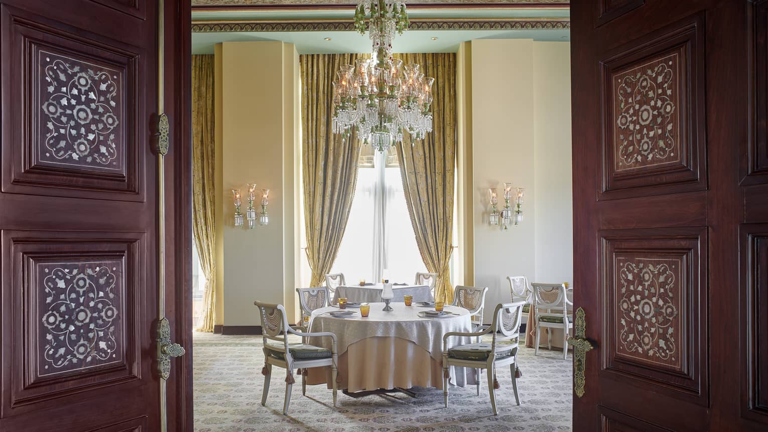 Byblos Restaurant dining area with gold curtains and chandelier