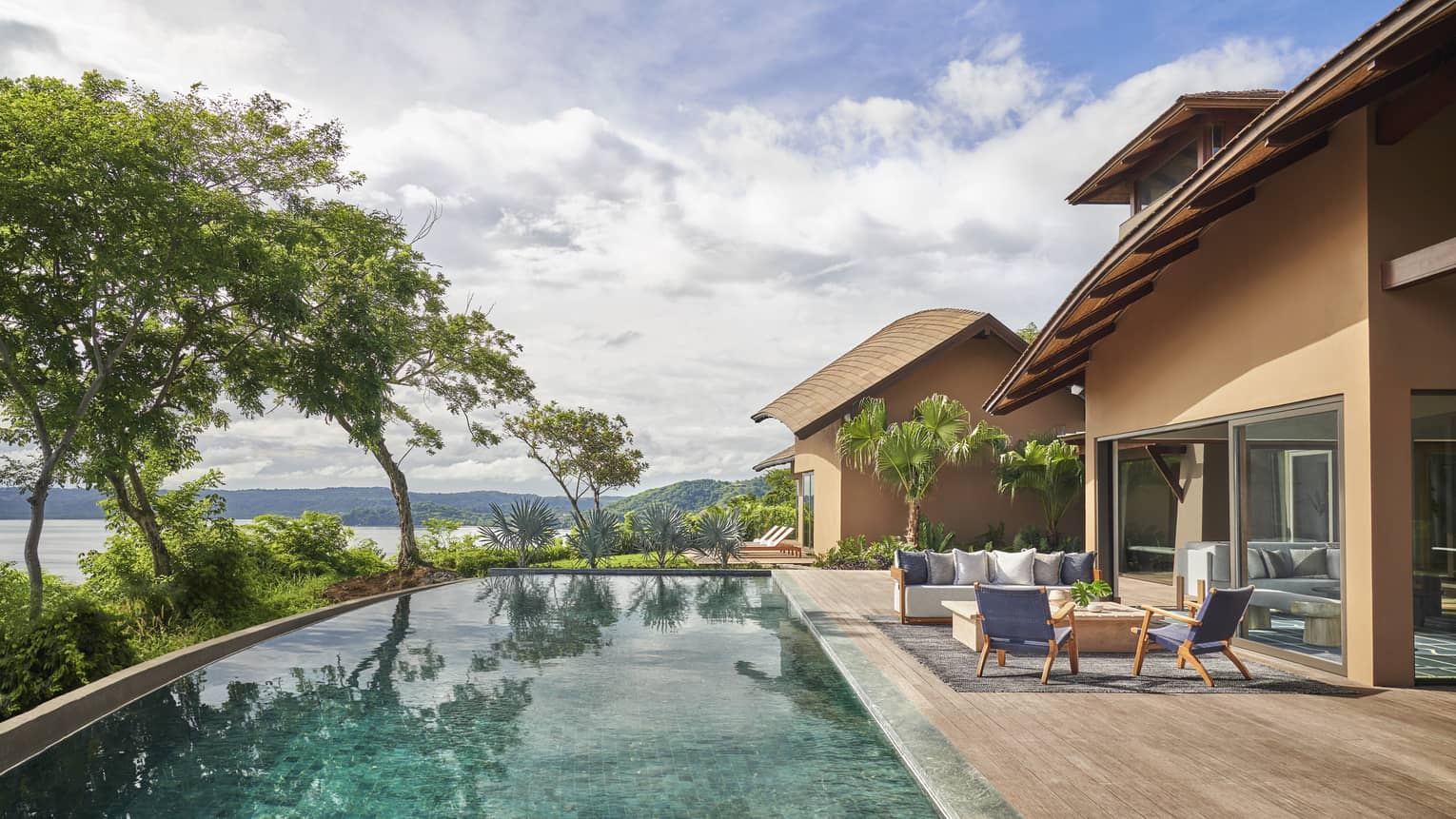 Private villa's pool with lounge furniture and sea views