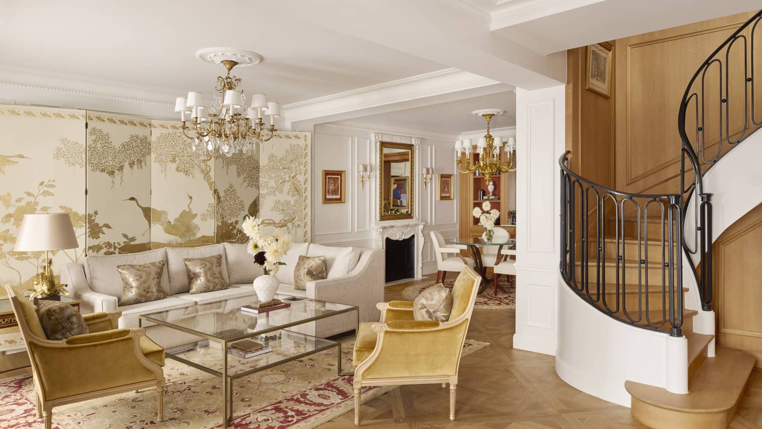 Opulent living room with curved staircase leading to upstairs