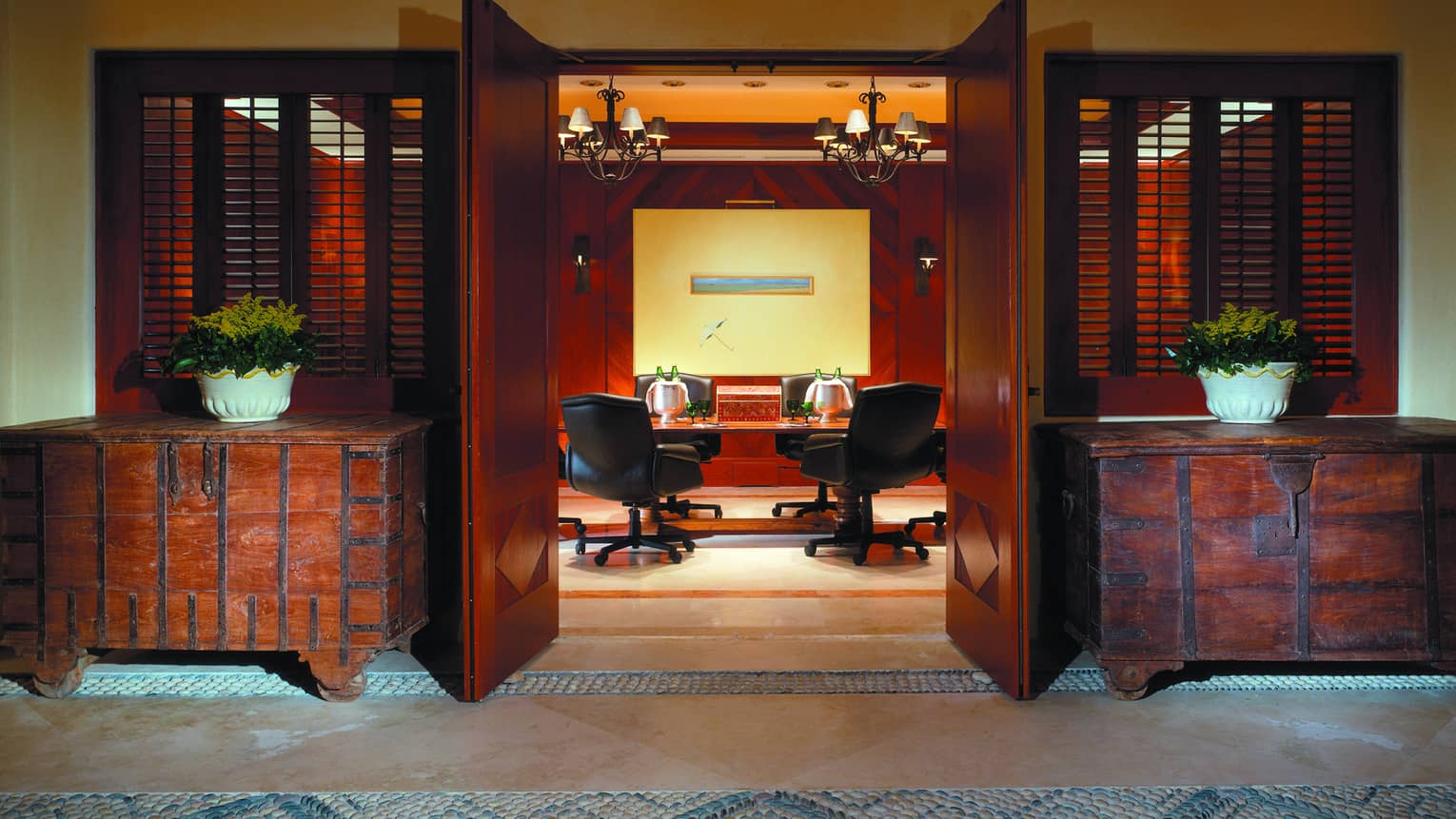 Rustic trunk cabinets flank open doors to Tau meeting room, table