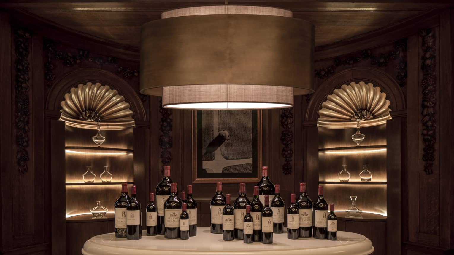 Chateau Latour wine tasting room, wine bottles on table under large modern light