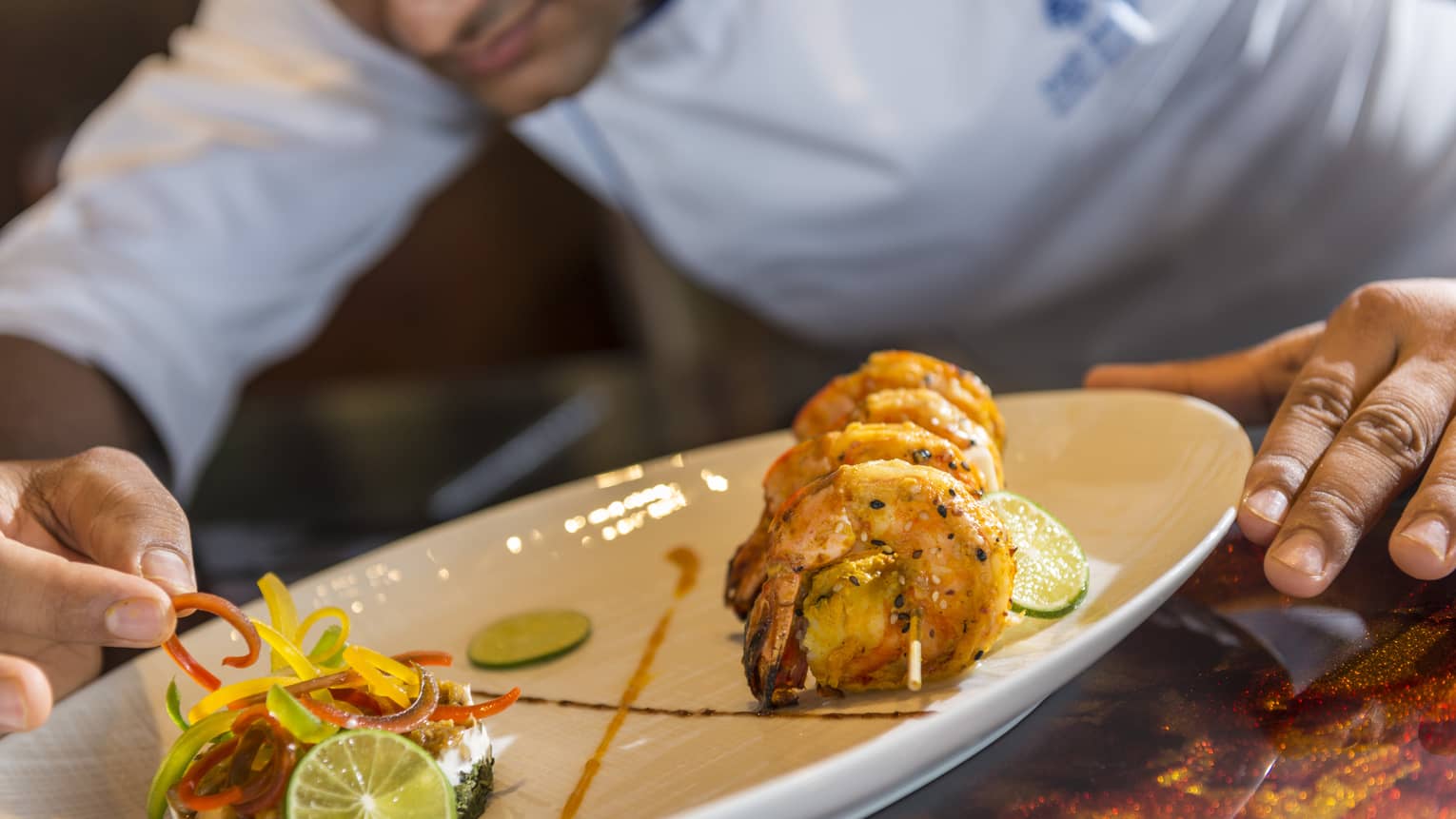 A chef plates some Baraabaru - Malabar Prawns