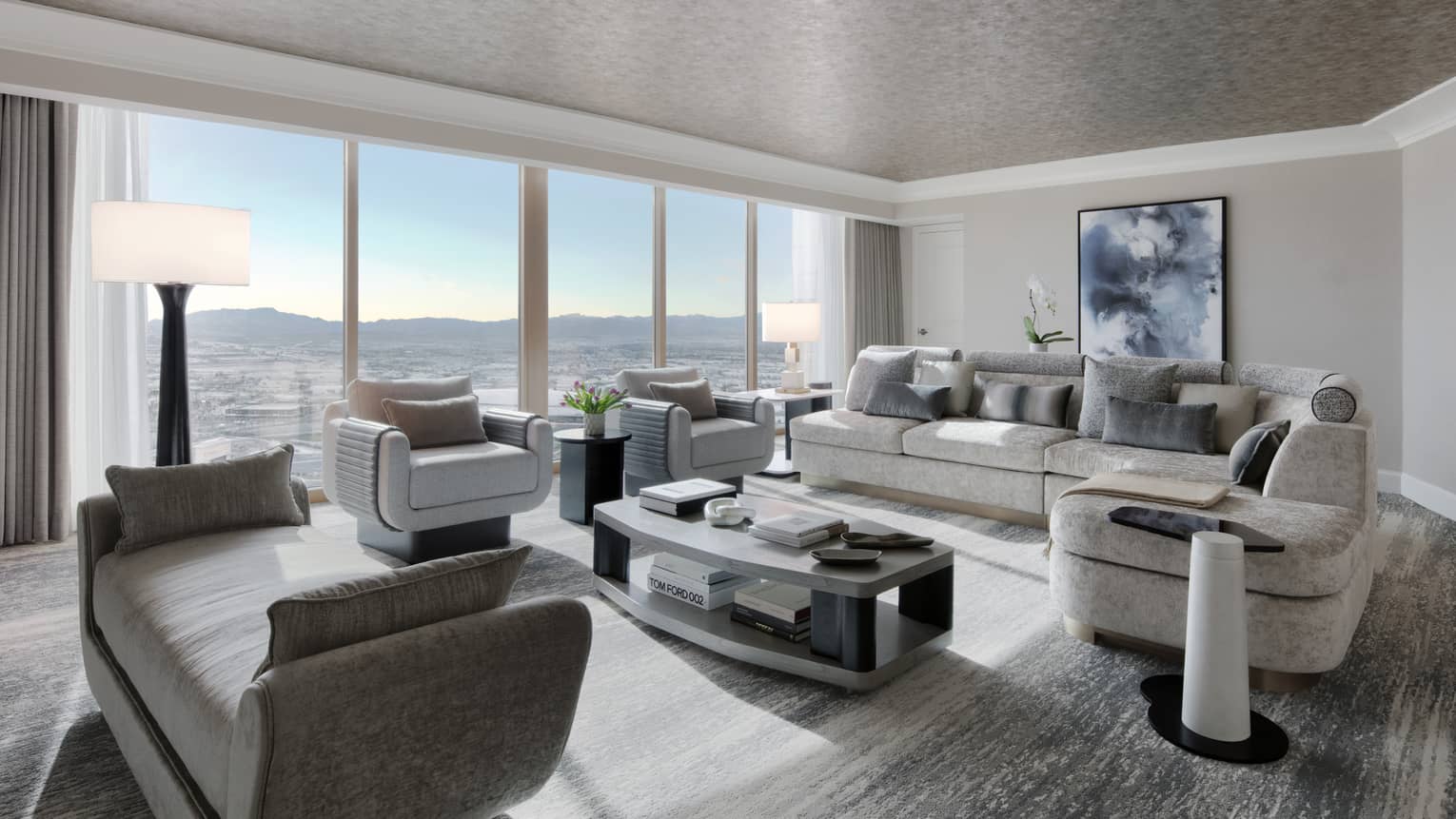 Large living room with sectional sofa, two arm chairs and chaise of luxury suite at Four Seasons Hotel Las Vegas