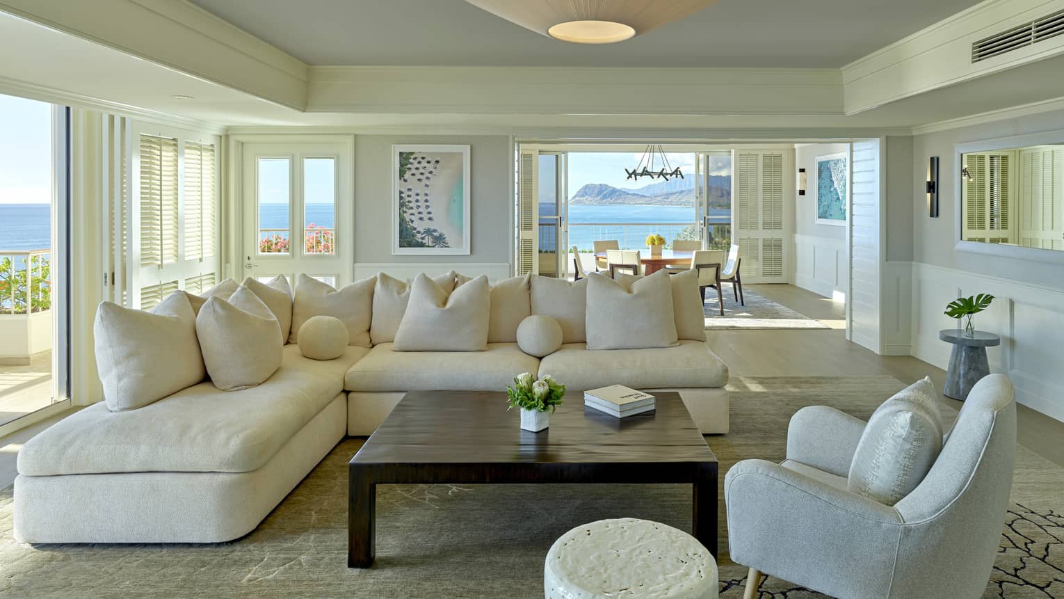 Living room with cream sectional sofa, grey arm chair, square table