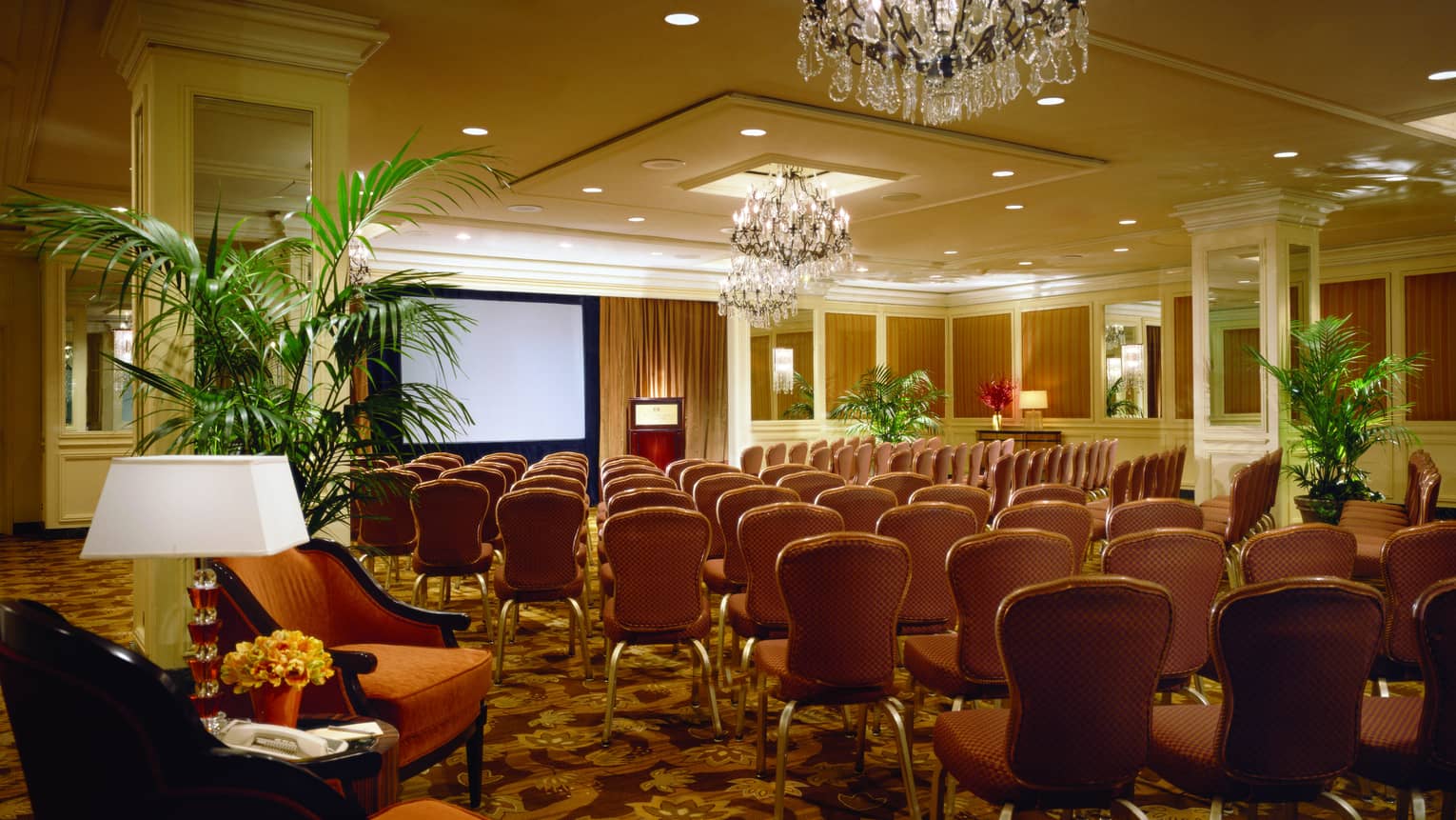 Rows of chairs facing large screen in Champagne Room