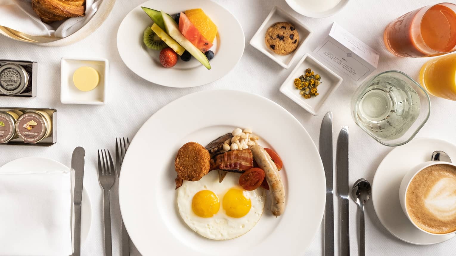 Aerial view of In-room Dining spread, including a full English breakfast, caf? latte, juice, fruit and pastries
