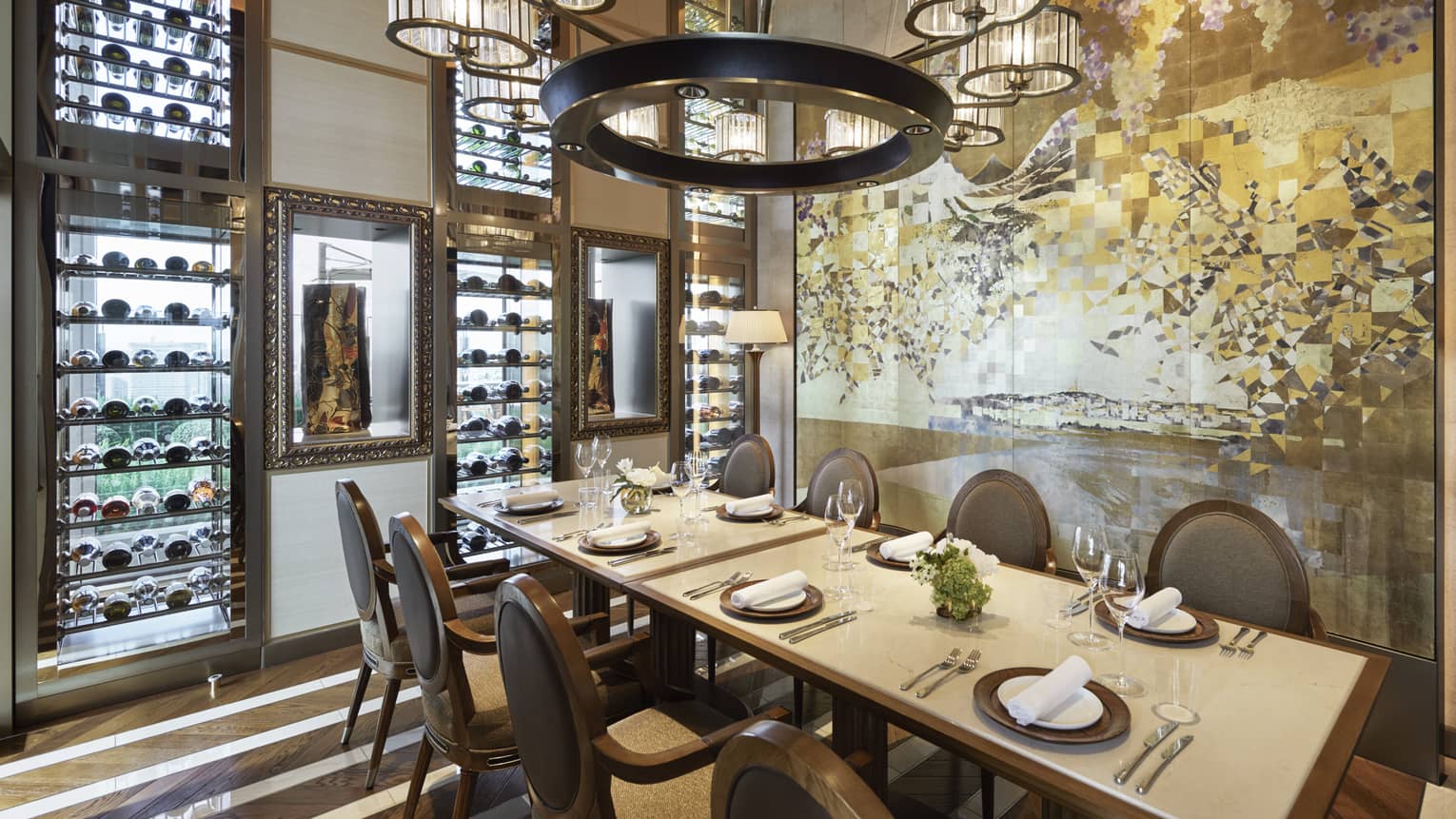 Est dining room with table set for eight, muted cream decor, circular chandelier, hardwood floors