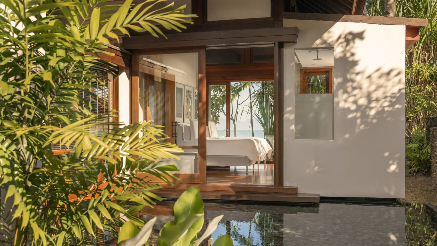 View of a Langkawi resort bedroom from the private garden terrace