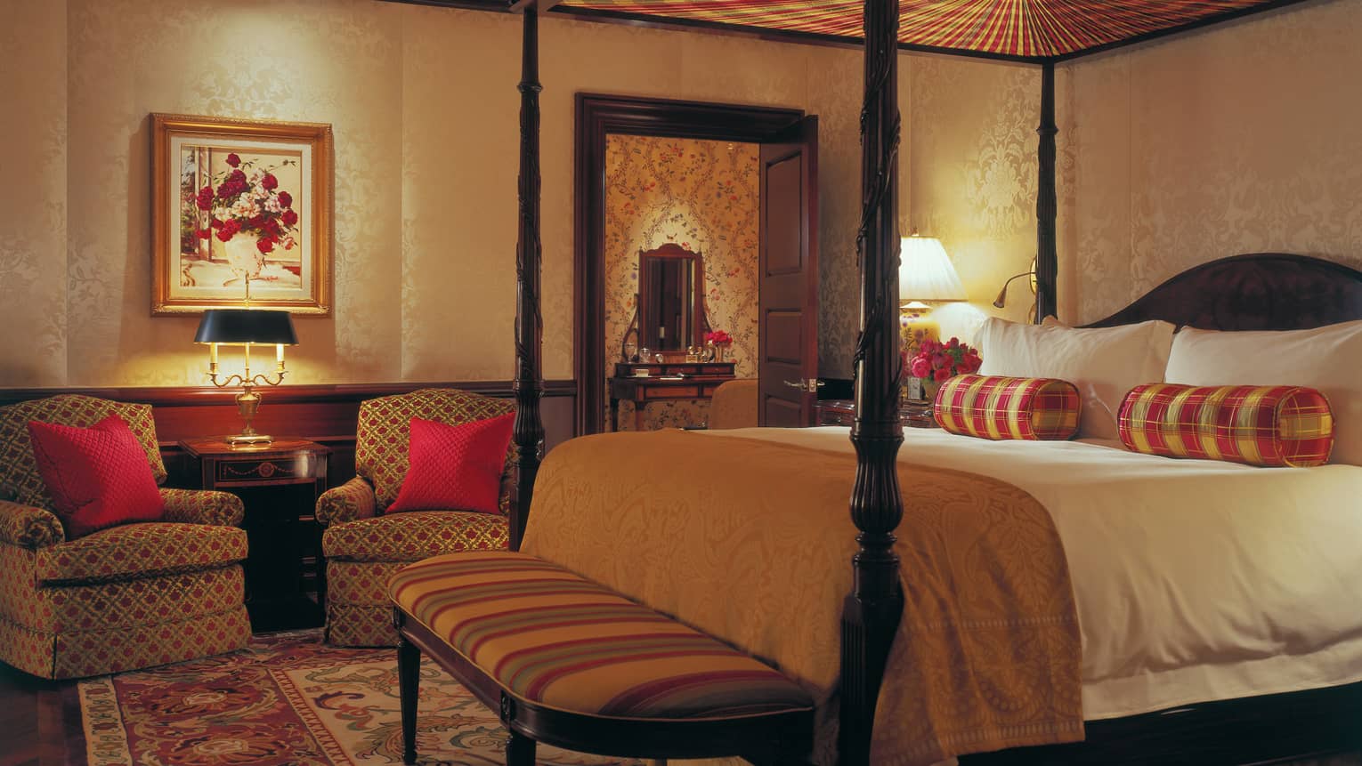 Presidential Suite poster bed, striped bench and pillows, armchairs with red pillows