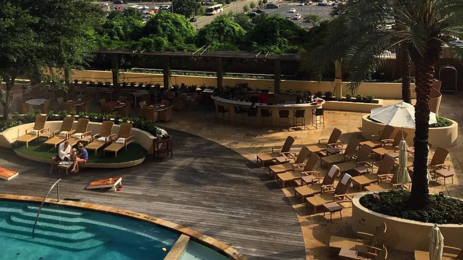 An outdoor pool with a city in the background.