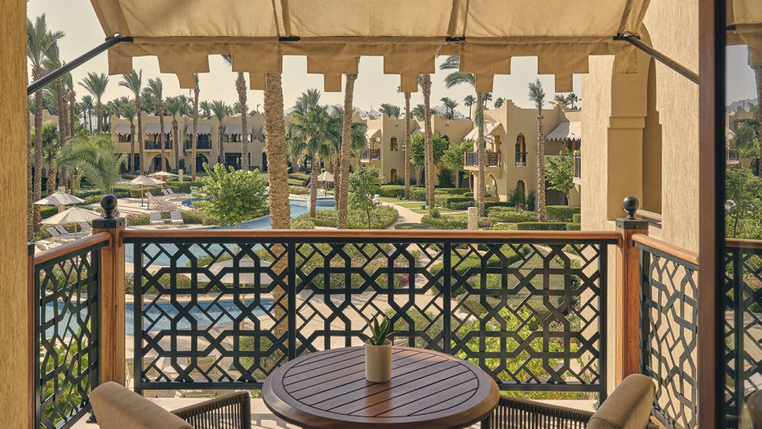 Private bedroom balcony overlooking resort pools
