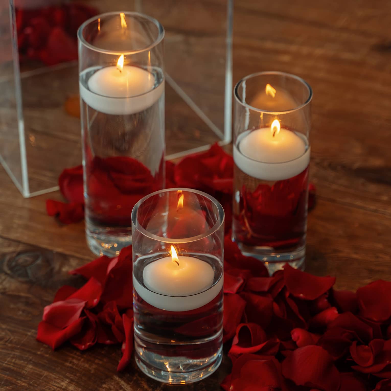 Three votive candles in glass pillars