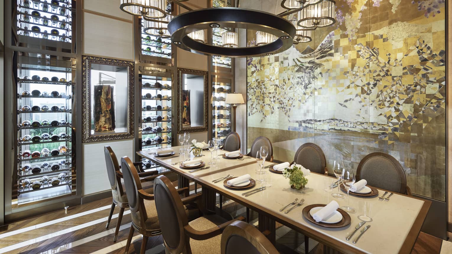 Est dining room with table set for eight, muted cream decor, circular chandelier, hardwood floors