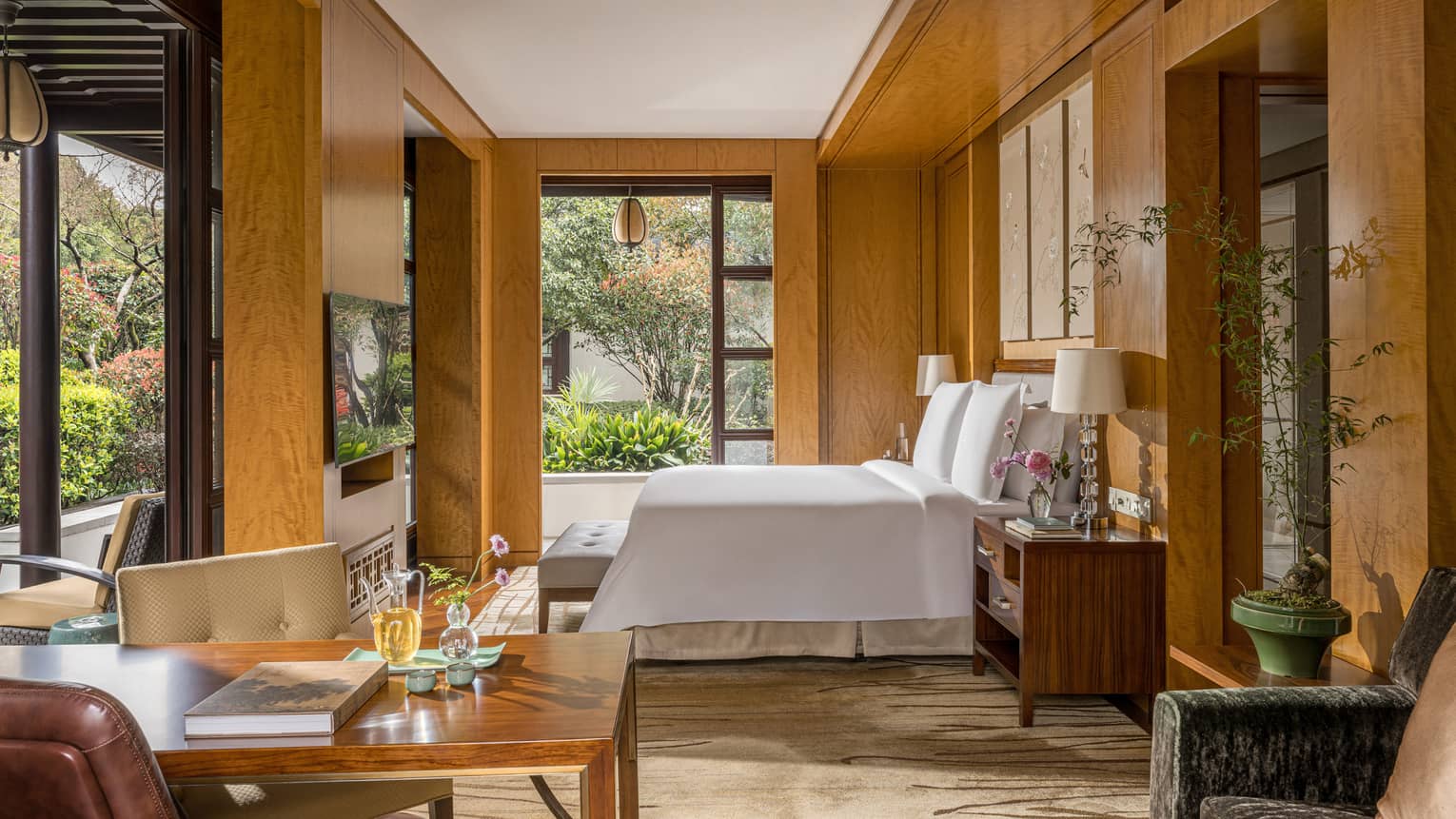 Luxury hotel guest room featuring king bed and garden views