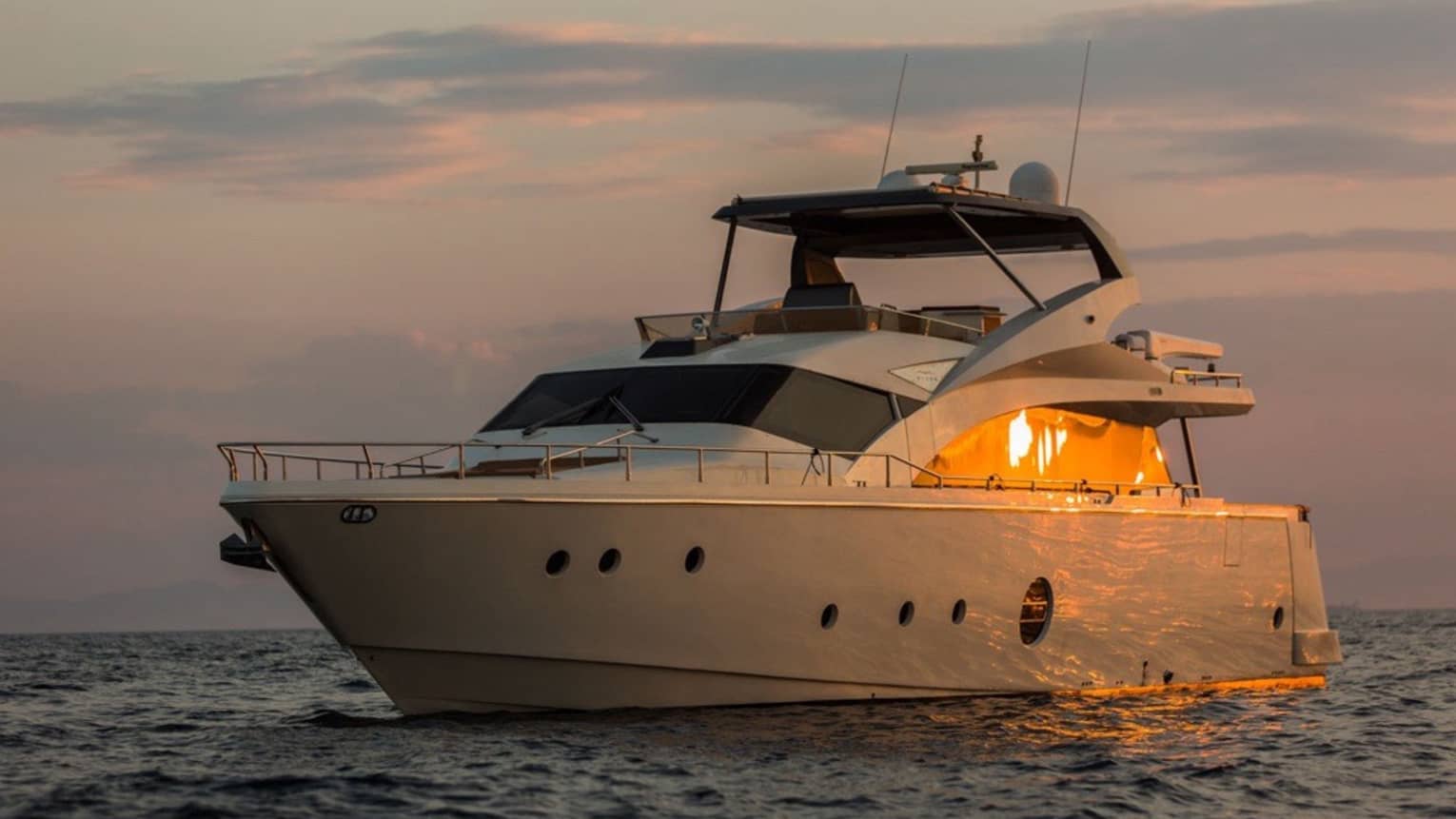 Private charter boat floats on the water at sunset
