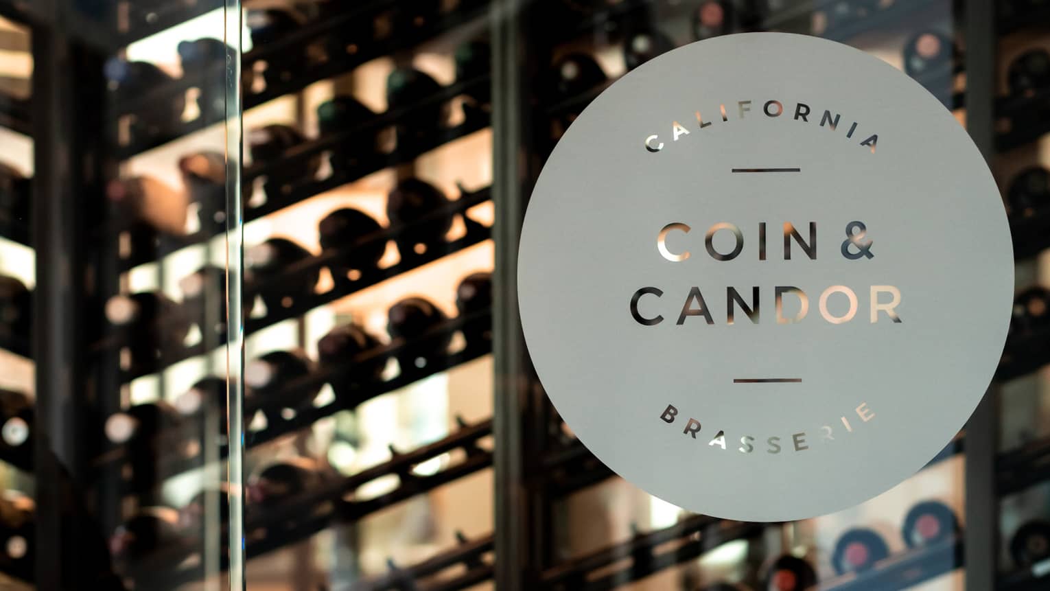 Glass door with Coin & Candor on it.