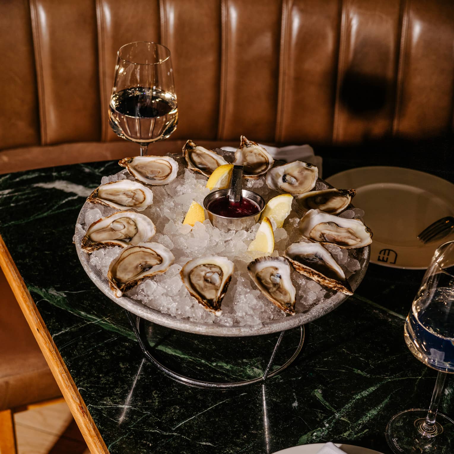Silver platter of oysters on ice