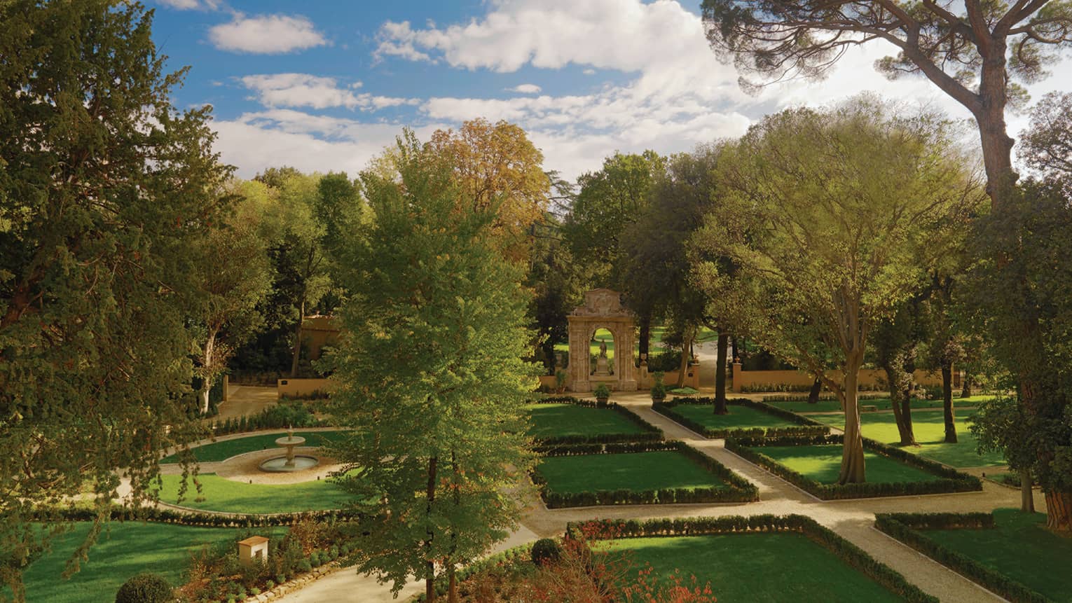 Looking out over green lawns, gardens, large tree, fountain