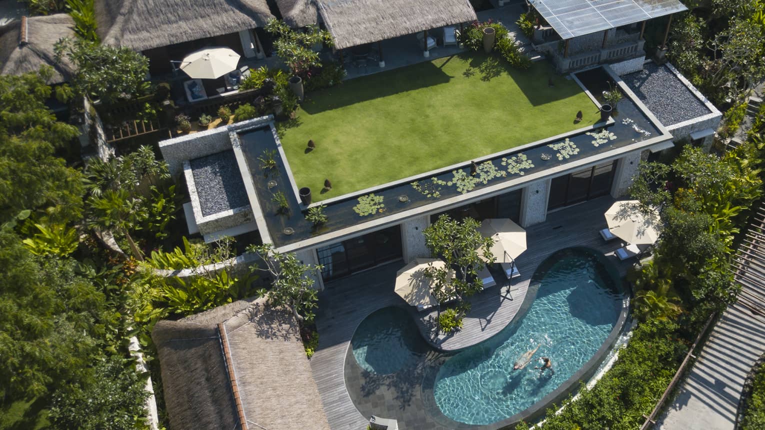 Aerial view of a large Balinese villa with private kidney-shaped pool