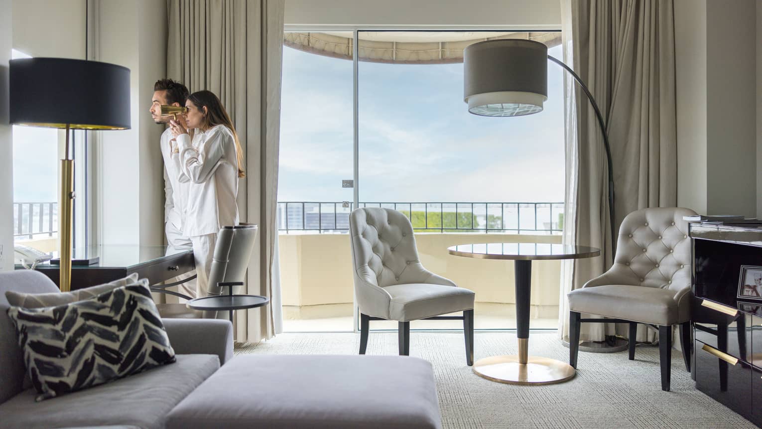 Two guests looking out of the window of their guest room