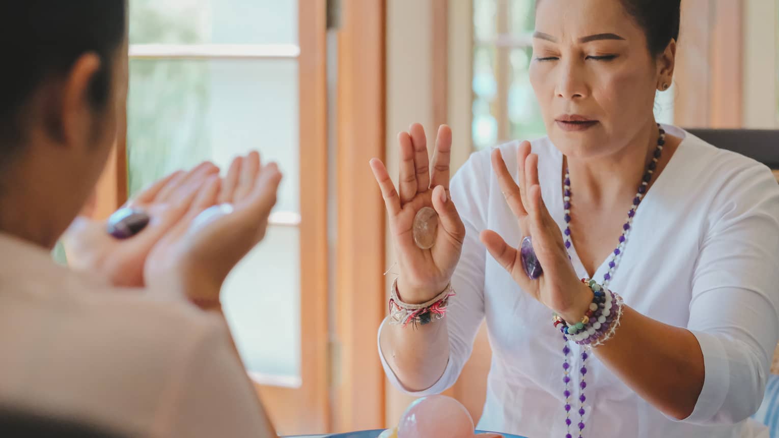 Healing Arts practitioner Ibu Jero conducts a crystal session