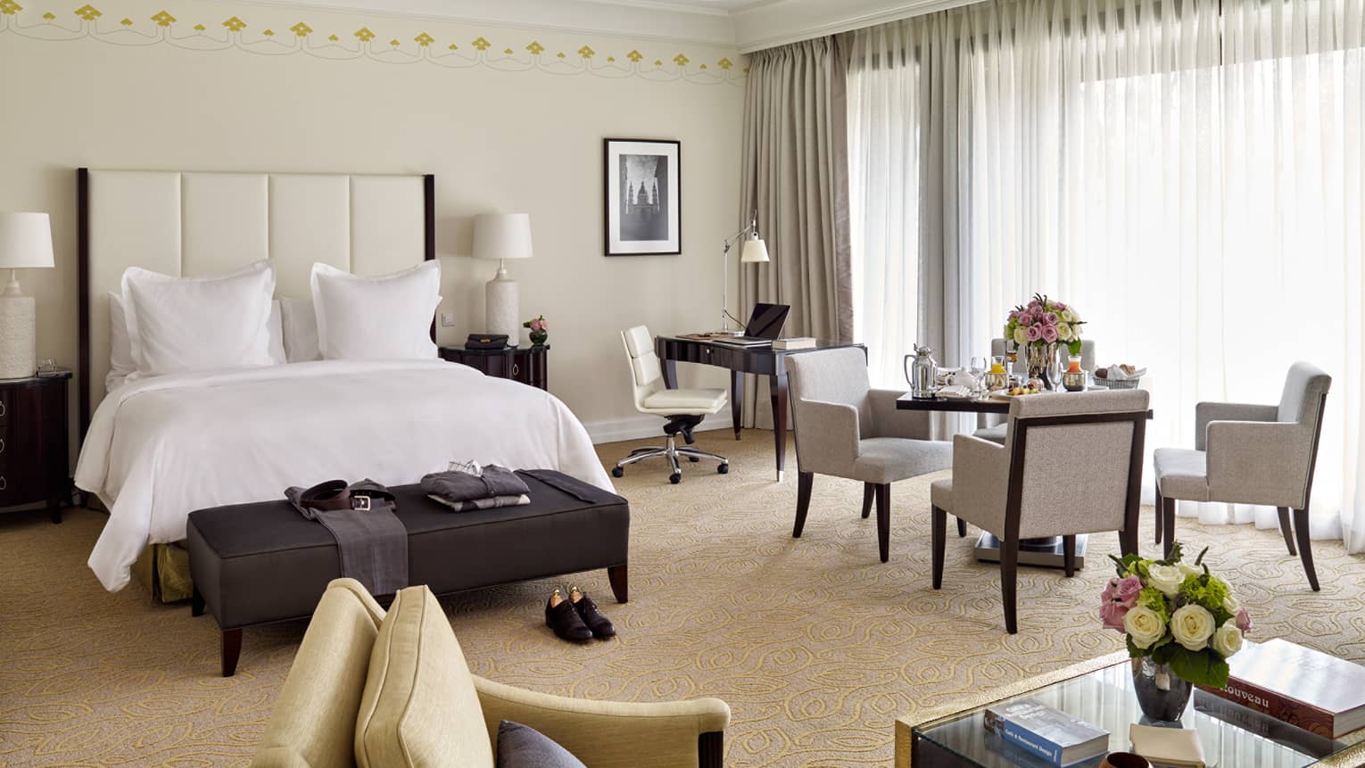 Park Suite dining table with in-room dining breakfast in front of long white curtains, beside bed and desk