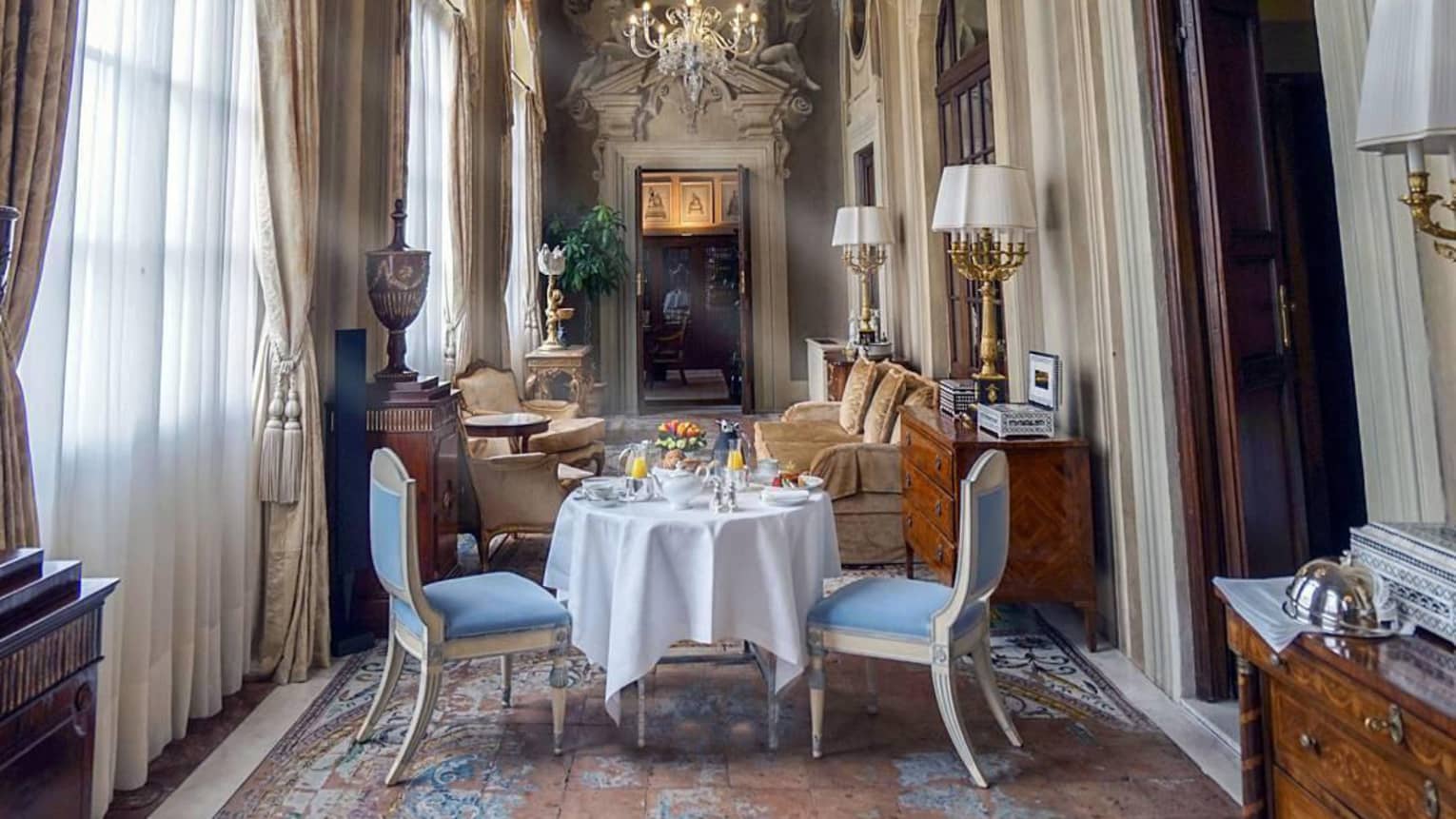 Royal Suite in-room dining table, seating room by tall sunny windows, ornate mouldings