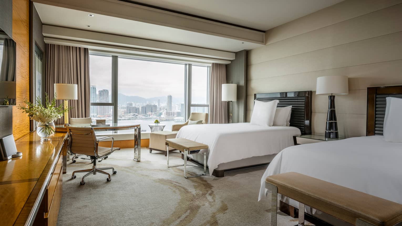 Premier Harbour-View Suite double beds with benches at foot, against padded panel wall