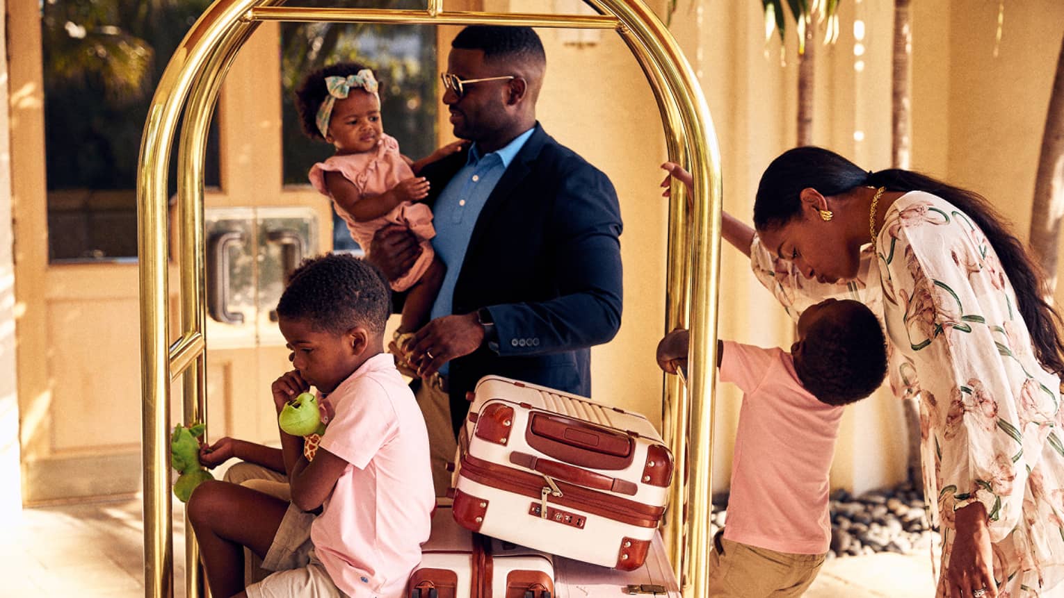A family arriving to a hotel or resort with luggage on a luggage carrier.