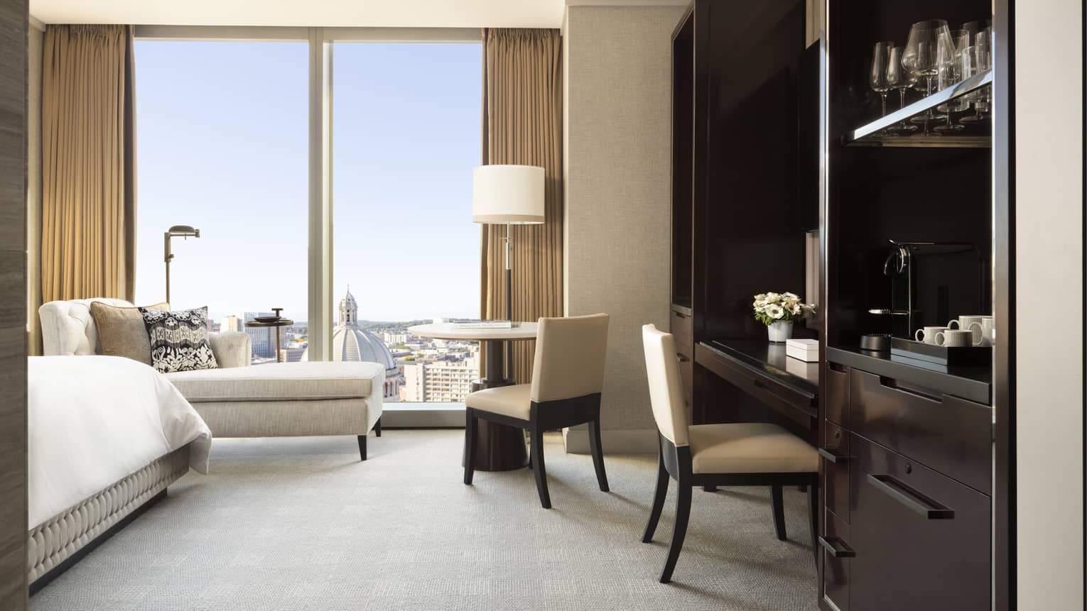 Built-in desk area in a guest room, with floor to ceiling windows overlooking Boston's Back Bay