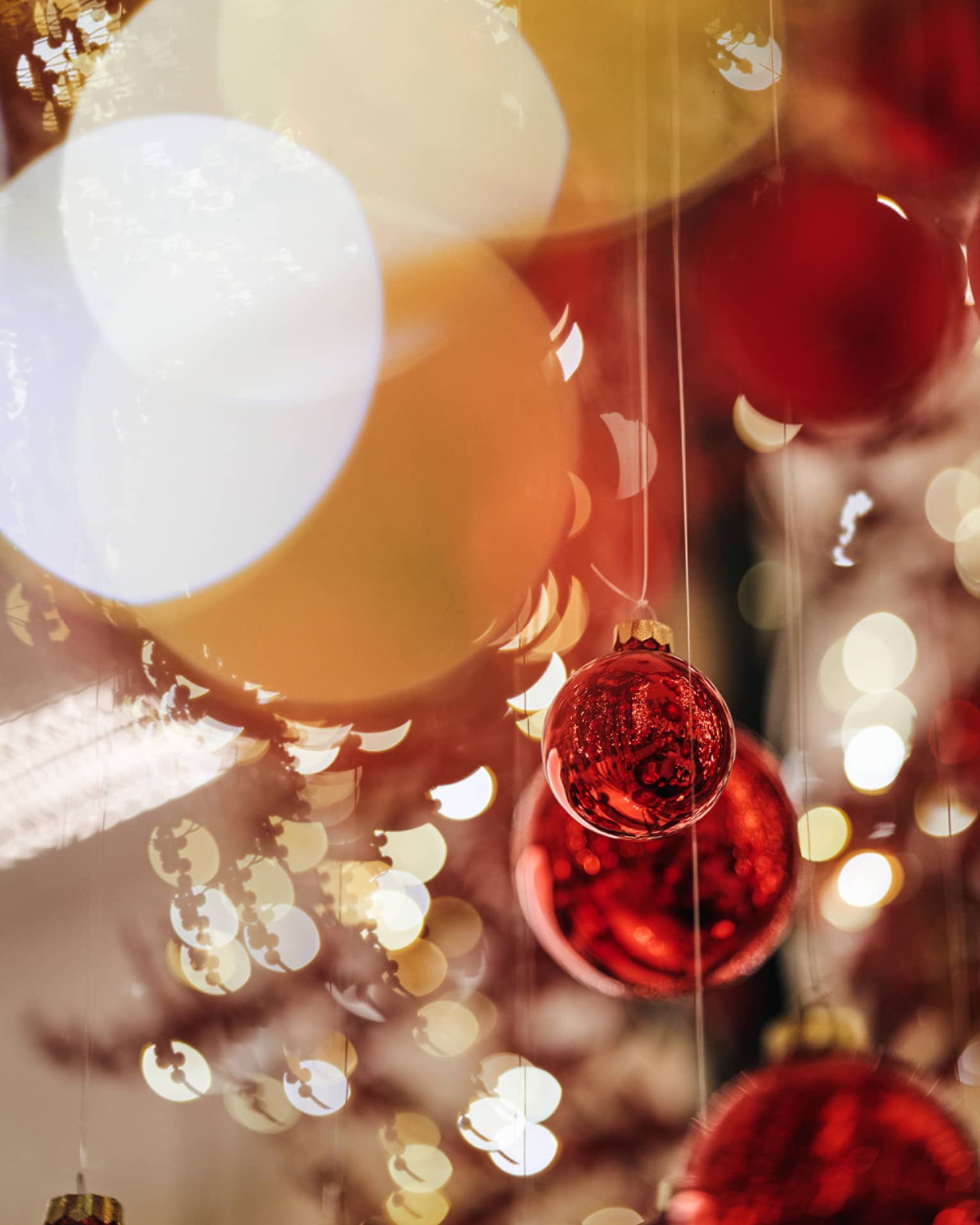 Red ball ornaments hanging from strings