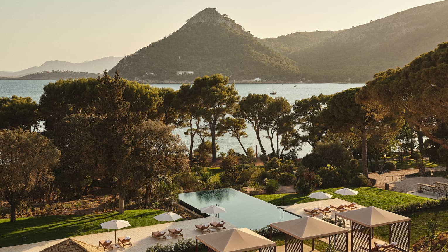 View of pool and ocean/mountain in background