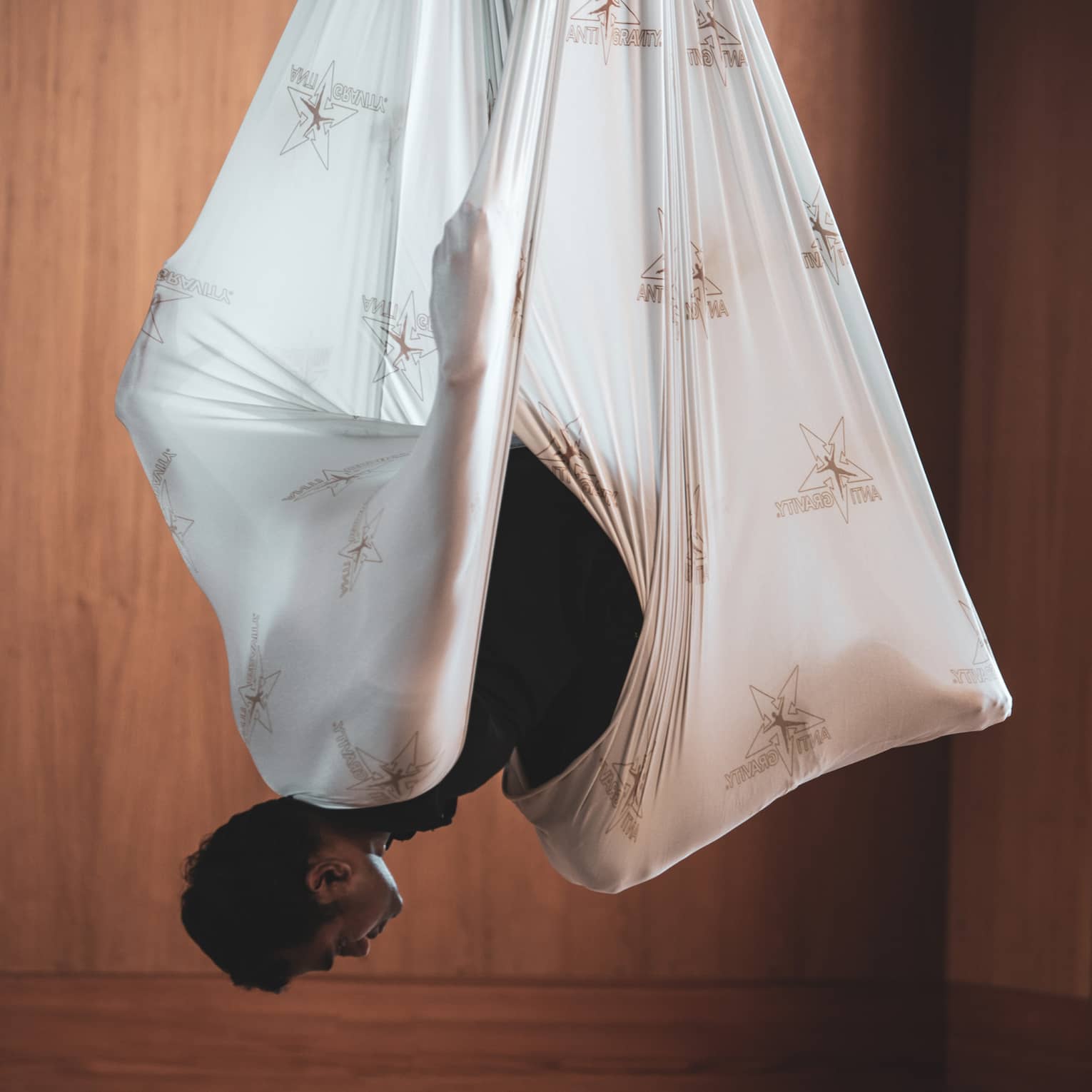 Man does aerial yoga