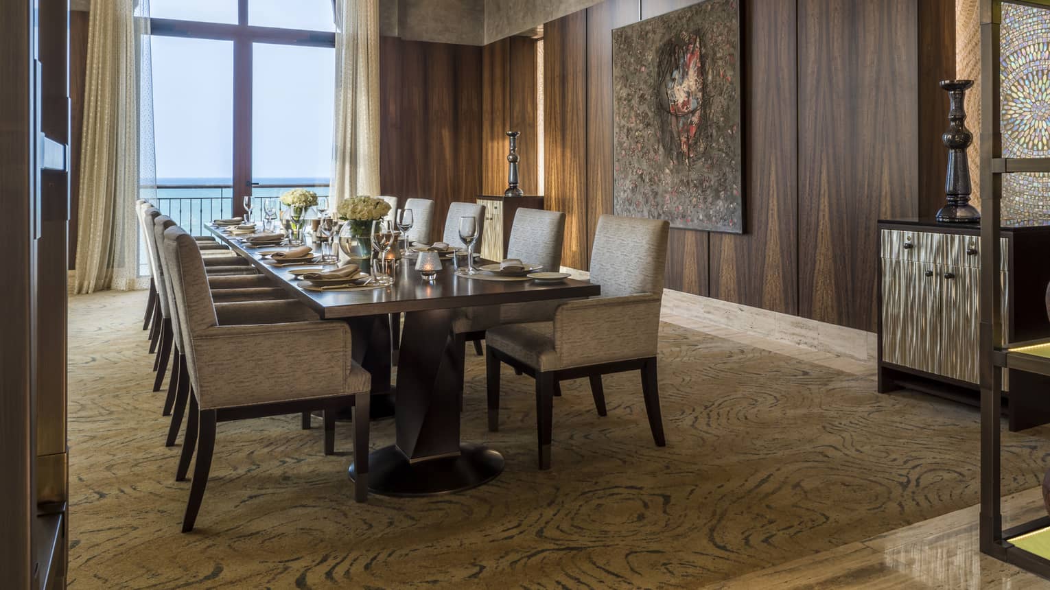Long dining table in private Creek Bistro dining room, wood paneled walls, view of ocean