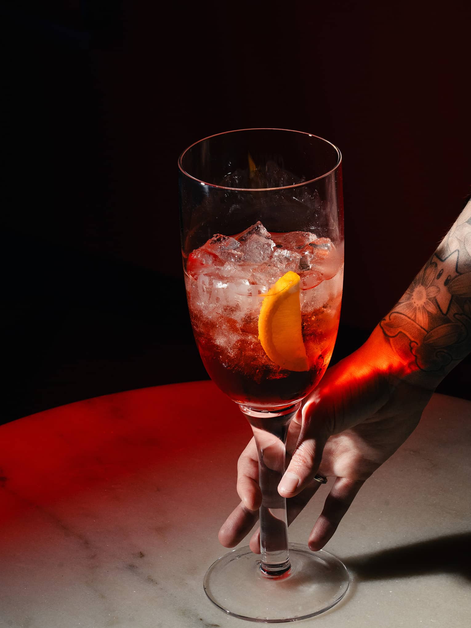 Sbagliato cocktail garnished with an orange slice