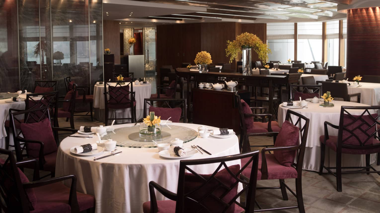 Round tables with white tablecloths in restaurant dining room