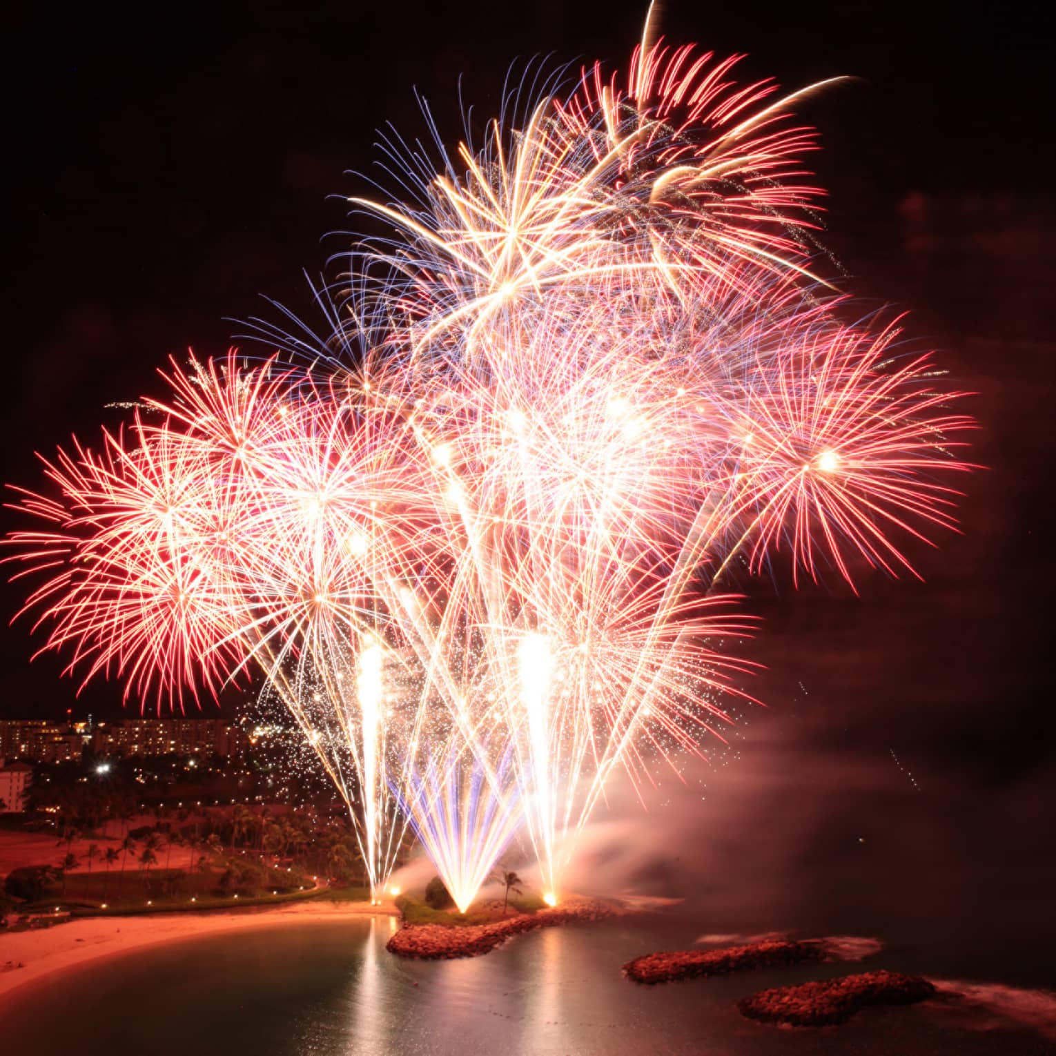 Red and yellow fireworks in a dark sky.