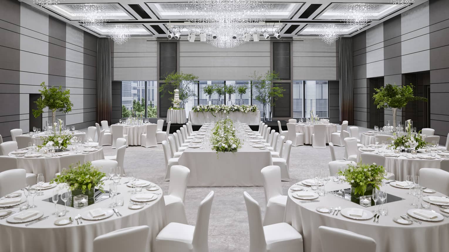 Wedding reception, round tables and chairs with white linens in ballroom 