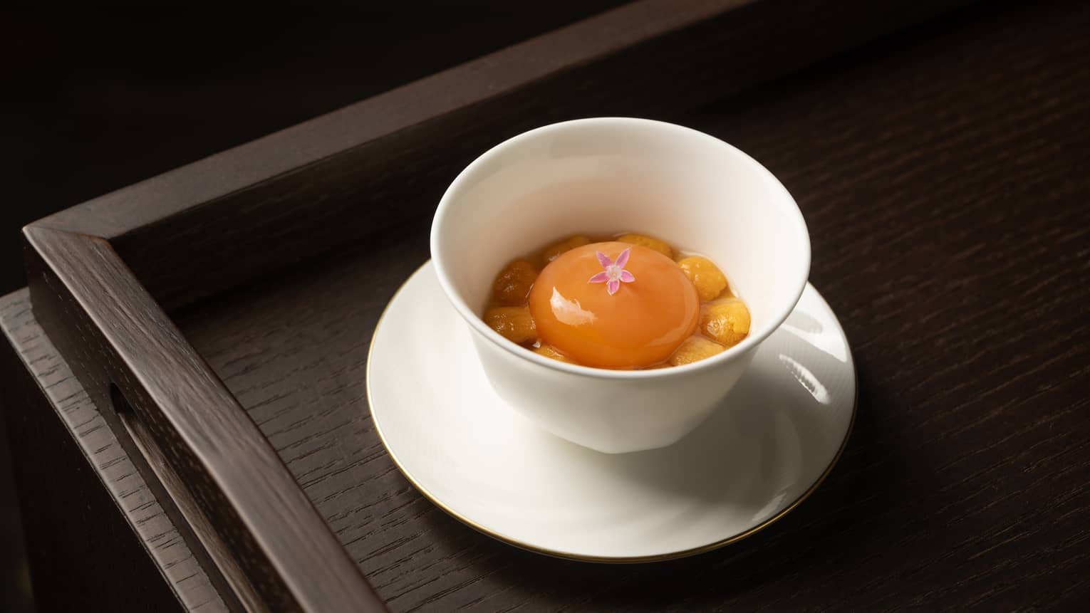 Soft boiled egg dish in a white cup