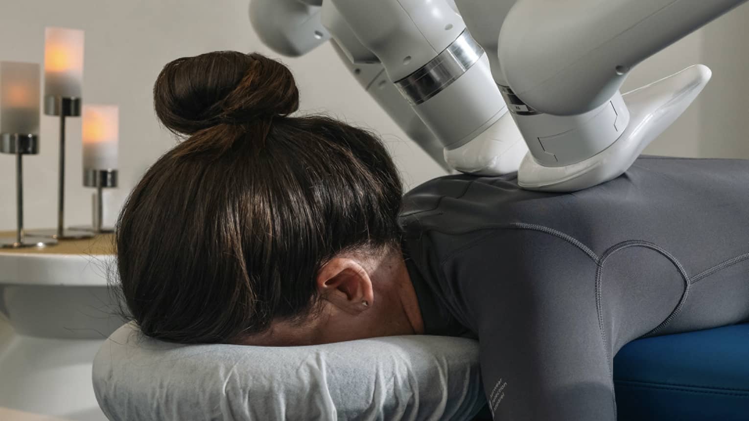 A guest laying on a massage table while getting a machined-powered massage