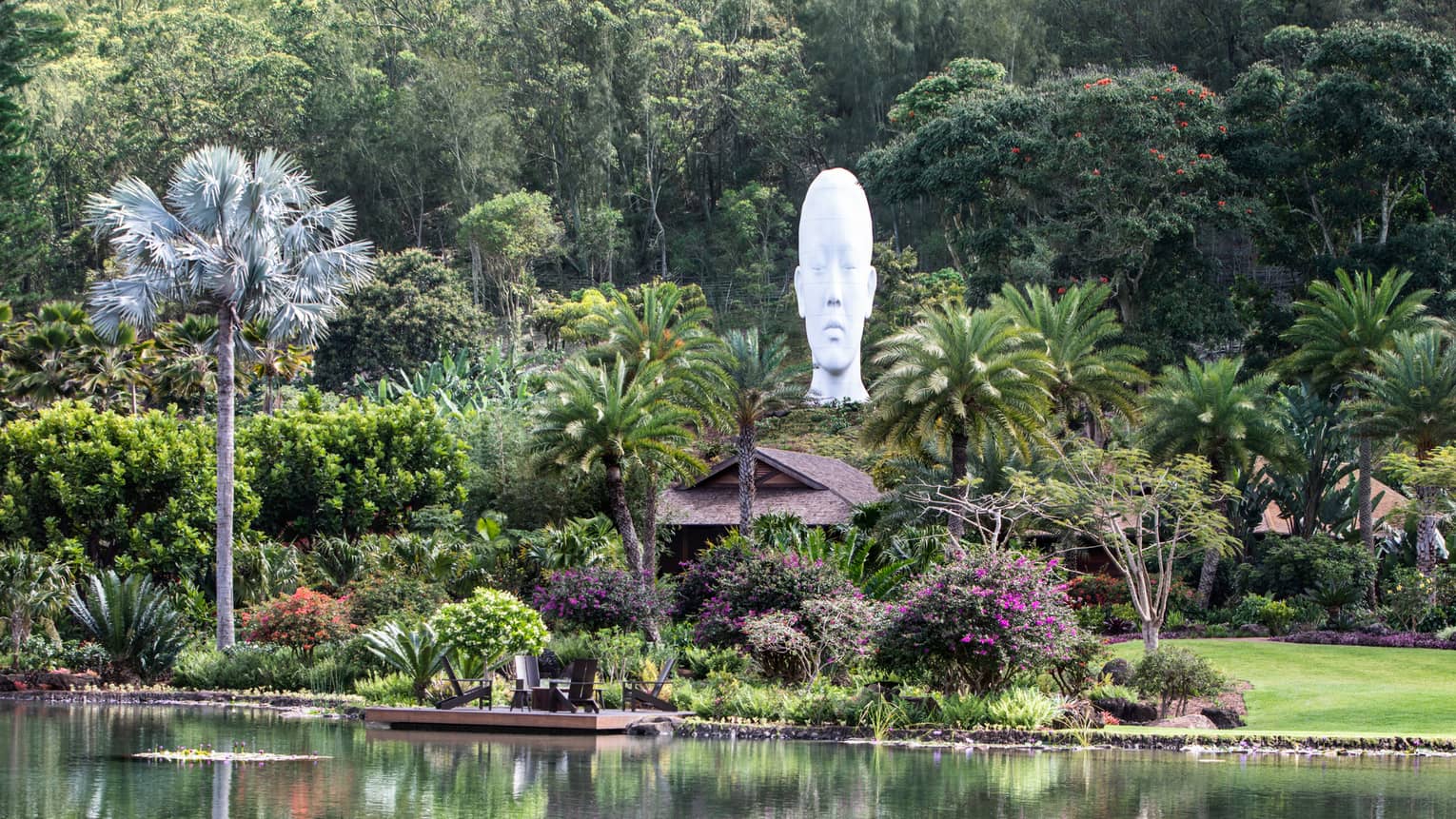 Lush tropical grounds of resort with sculpture head