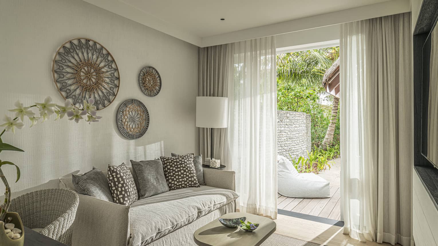 Bedroom with sofa, desk and walk-out deck with lounge chair