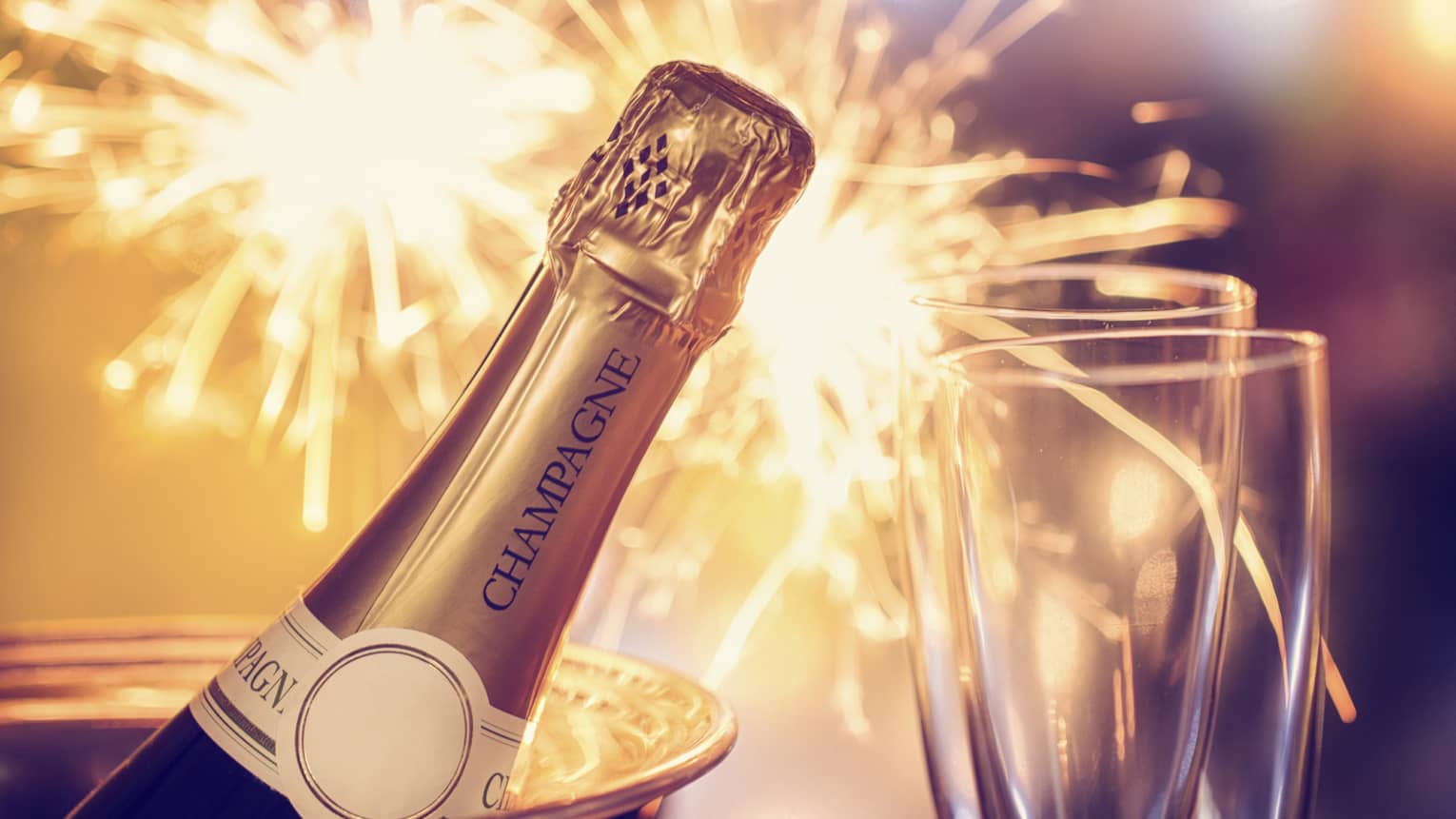 Fireworks, champagne and two champagne flutes
