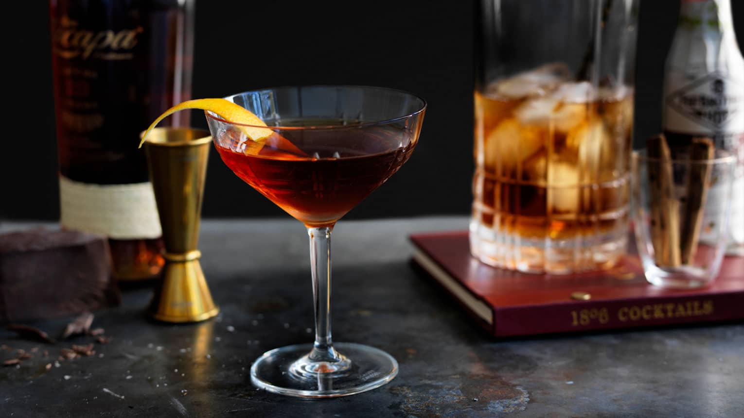 Old Fashioned cocktail in martini glass with orange peel garnish
