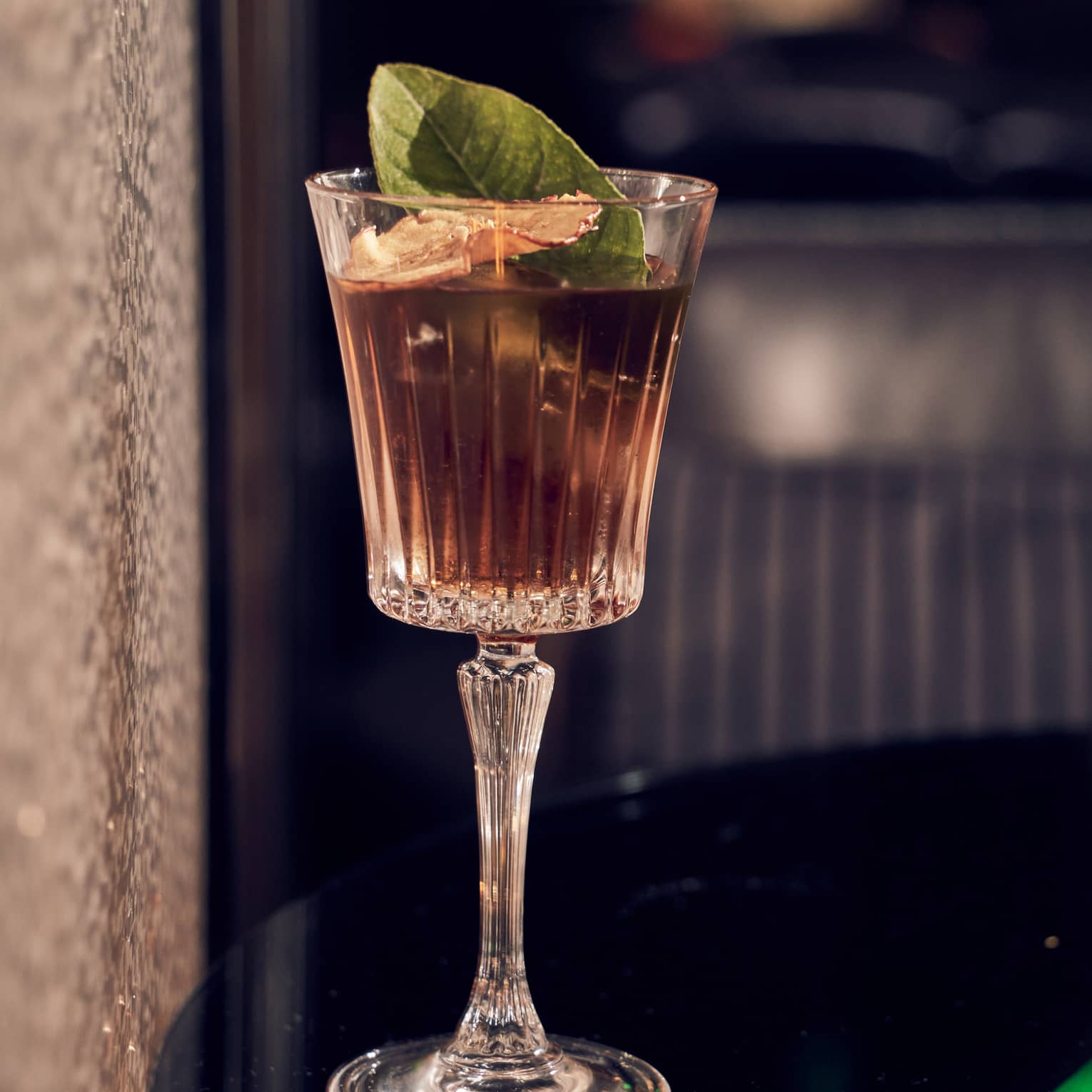 A cocktail on a black table.