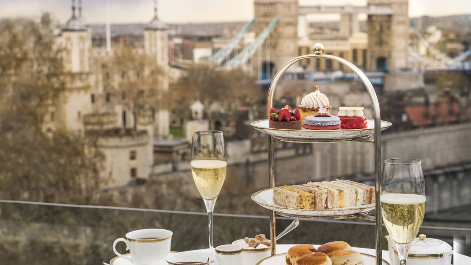 Afternoon tea patio dining table, tray with scones and sweets, Champagne glasses 