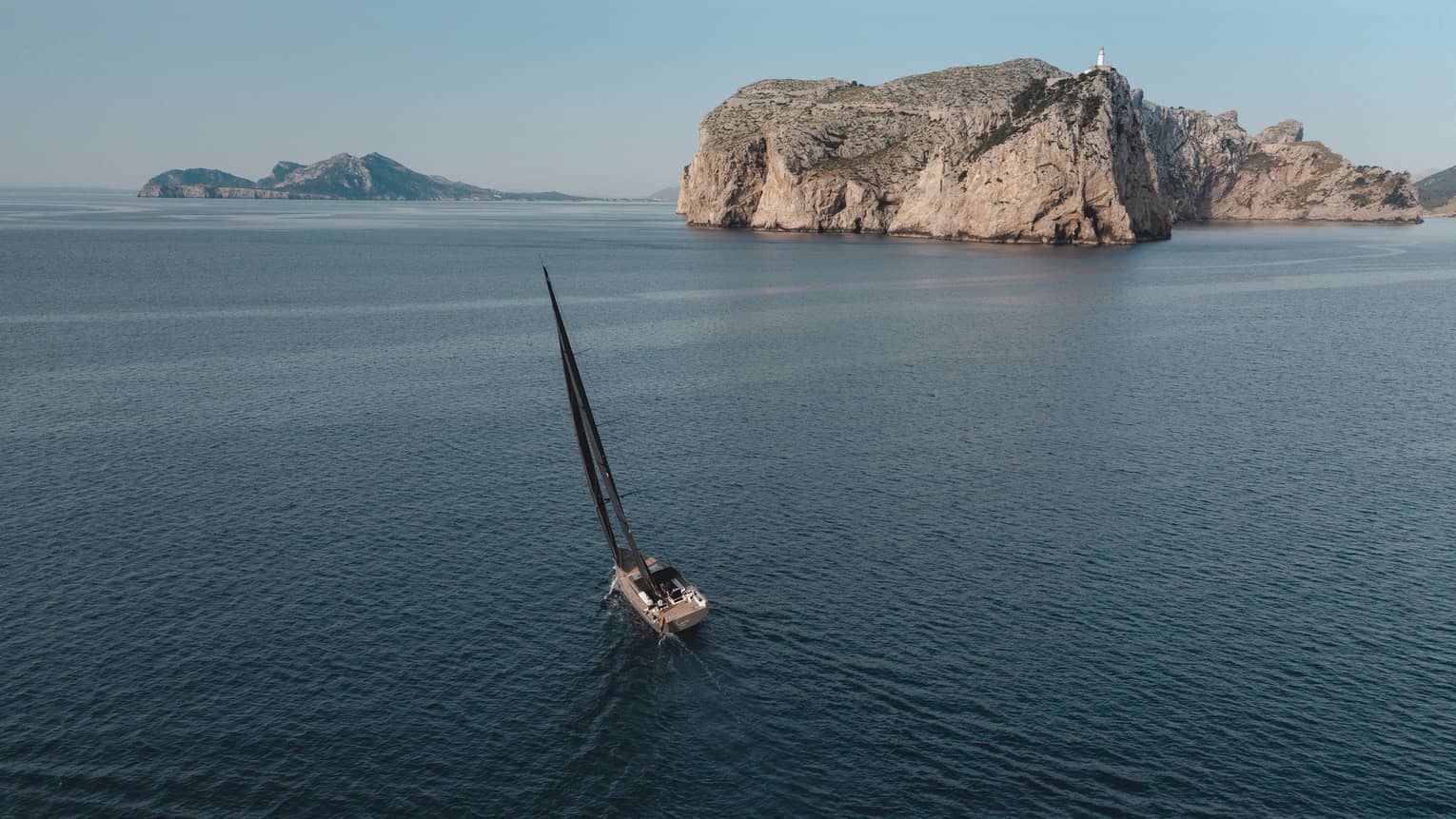 Sailboat glides along the sea near Cap de Formentor, Mallorca