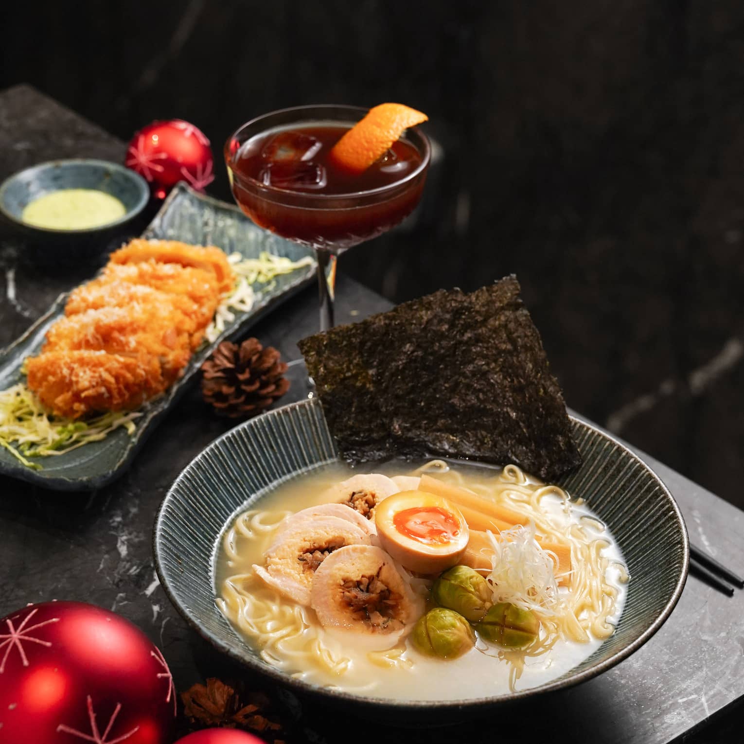 Bowl of gourmet Ramen and a holiday cocktail