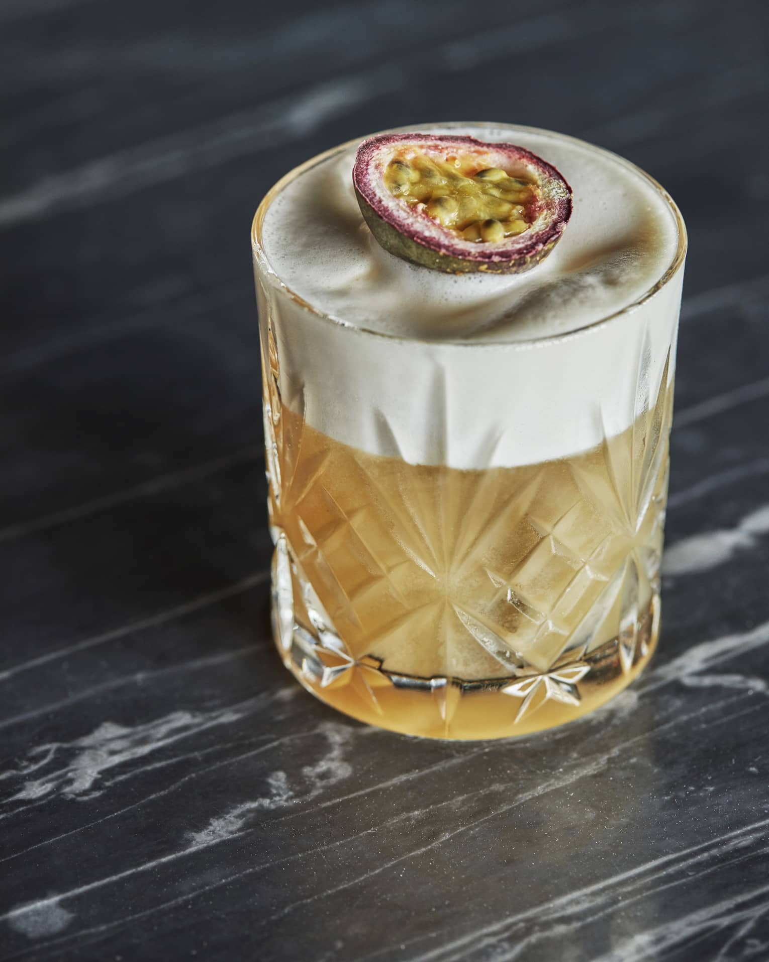 A cocktail in a glass with a fruit slice on top