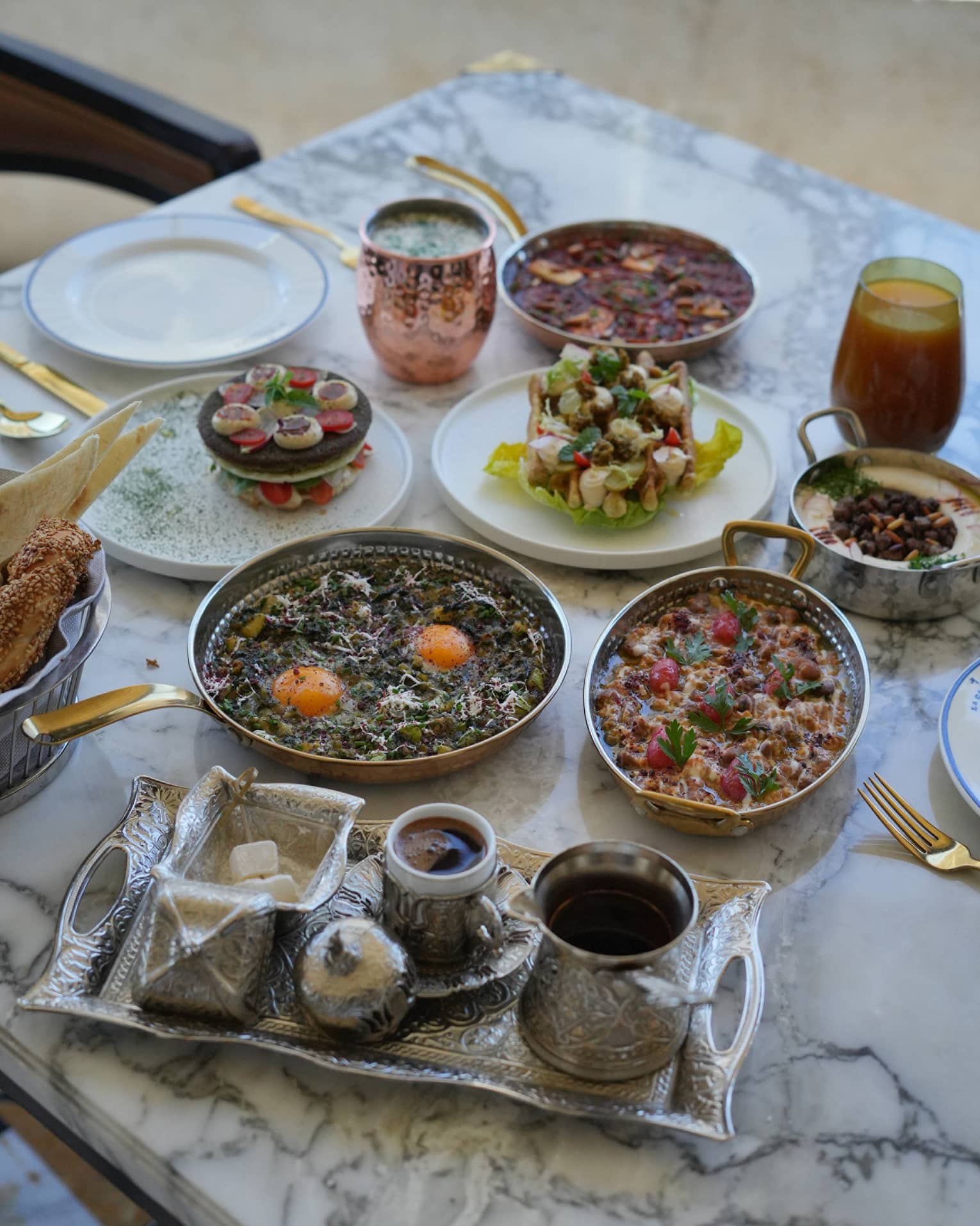 Traditional Jordinian breakfast spread set on a white marble table
